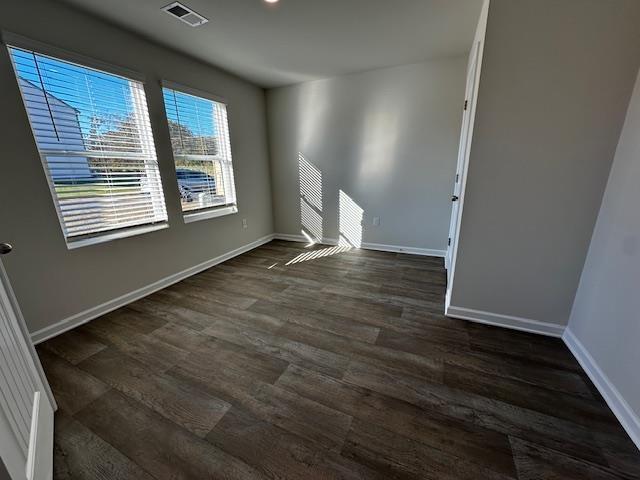 spare room with dark wood-type flooring