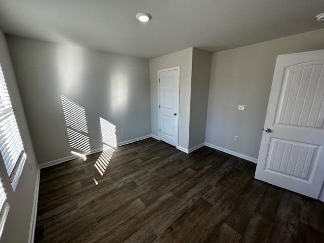 empty room with dark hardwood / wood-style floors