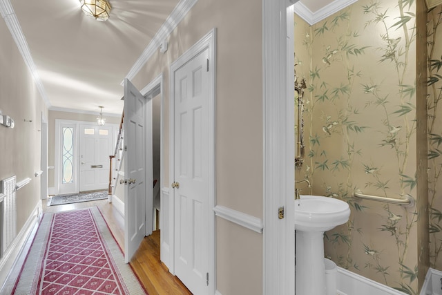 bathroom featuring crown molding and hardwood / wood-style flooring