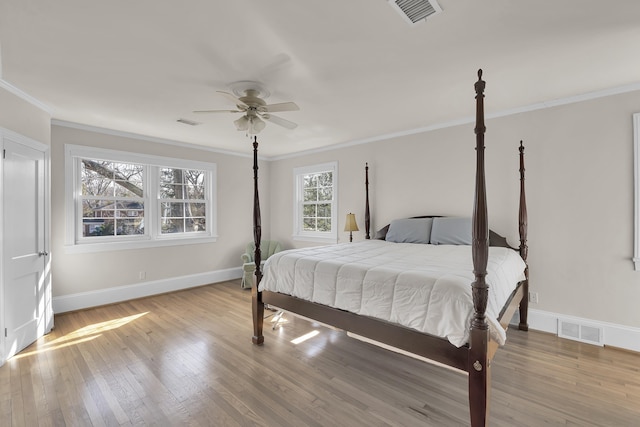 bedroom featuring crown molding, ceiling fan, and light wood-type flooring