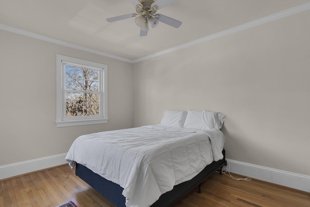 bedroom featuring crown molding, ceiling fan, and wood-type flooring