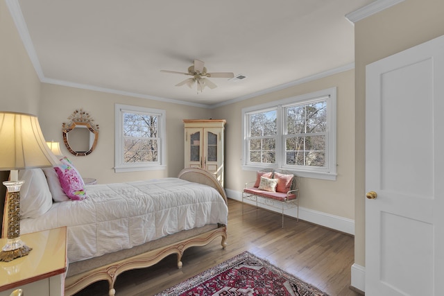 bedroom with hardwood / wood-style flooring, crown molding, and ceiling fan