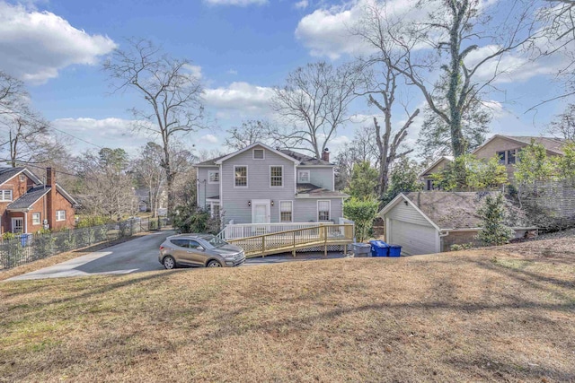 view of front of home featuring a deck and a front lawn