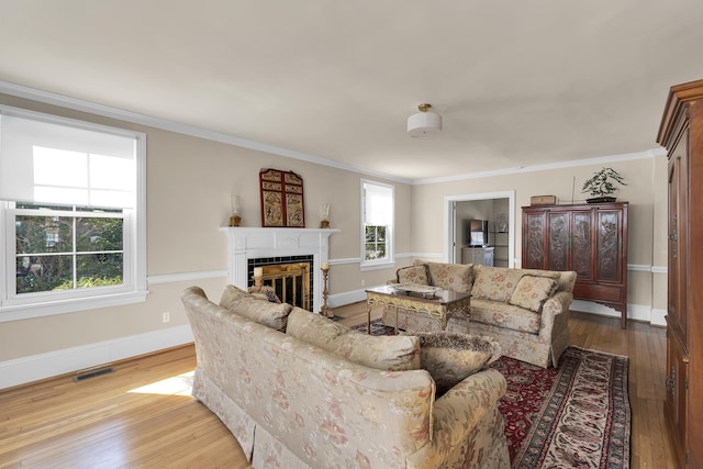 living room featuring ornamental molding and light hardwood / wood-style floors