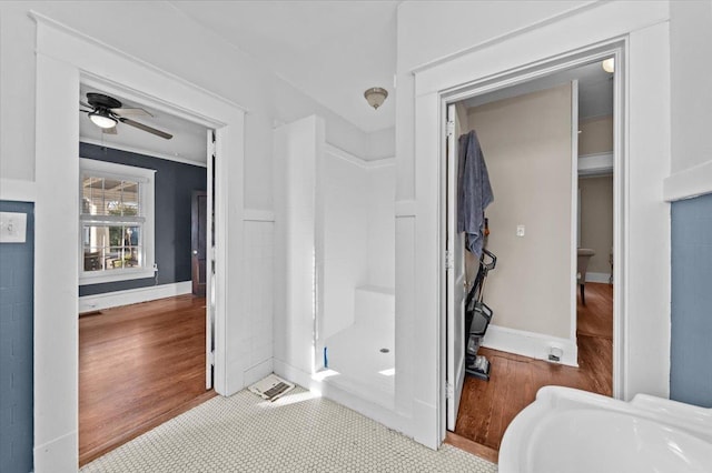 bathroom with hardwood / wood-style flooring and ceiling fan