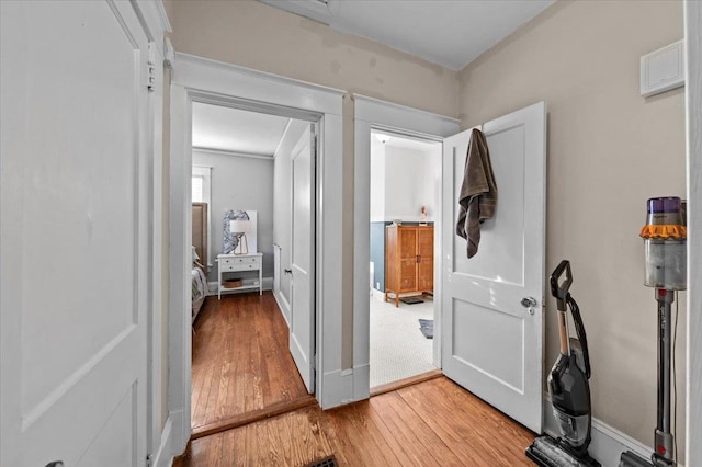 hallway with hardwood / wood-style flooring