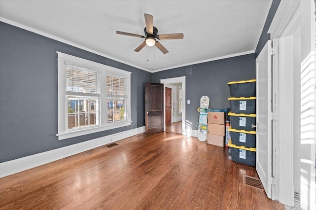 unfurnished bedroom featuring crown molding, hardwood / wood-style flooring, and ceiling fan