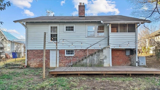 rear view of house featuring a wooden deck