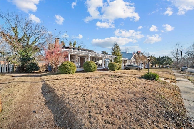 view of front of property with a pergola