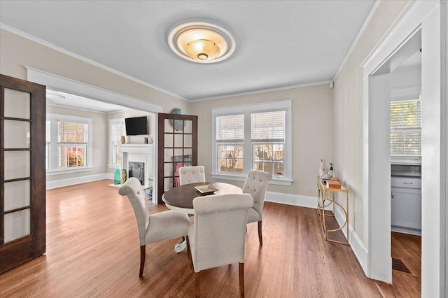 dining room with crown molding and hardwood / wood-style flooring