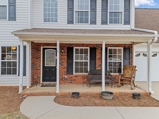 property entrance featuring a garage and covered porch