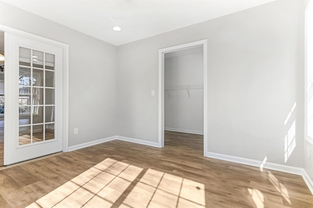 unfurnished room with wood-type flooring