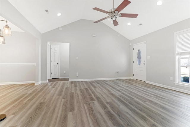 unfurnished living room with ceiling fan, high vaulted ceiling, and hardwood / wood-style floors