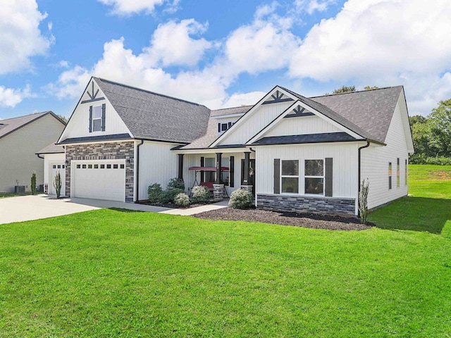 view of front facade with a garage, a front yard, and covered porch