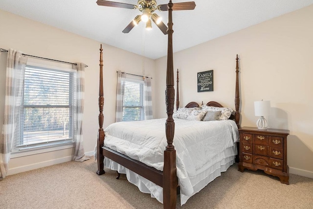 bedroom featuring vaulted ceiling, light carpet, and ceiling fan