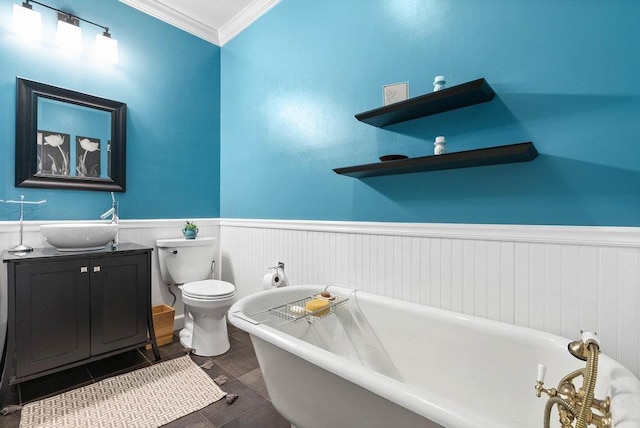 bathroom with vanity, crown molding, a tub, and toilet