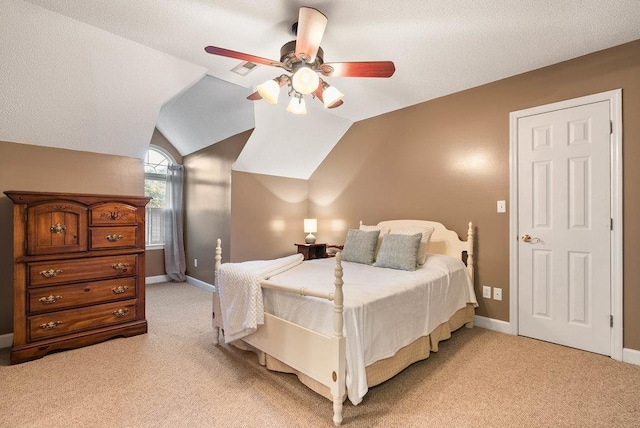 carpeted bedroom with ceiling fan, lofted ceiling, and a textured ceiling