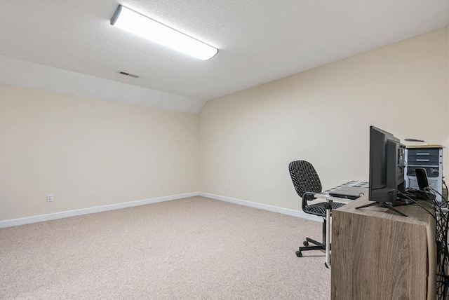 office area with light colored carpet, lofted ceiling, and a textured ceiling