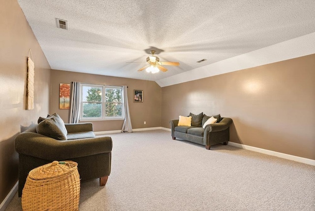 living room with vaulted ceiling, light carpet, a textured ceiling, and ceiling fan