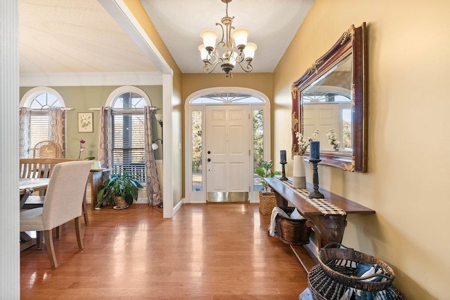 foyer entrance featuring an inviting chandelier and wood-type flooring