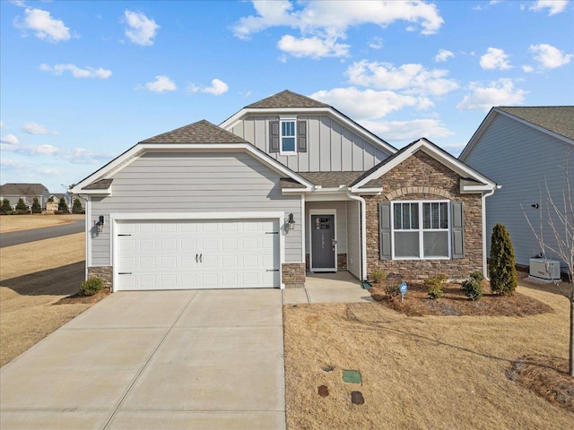 craftsman house with central AC unit and a garage