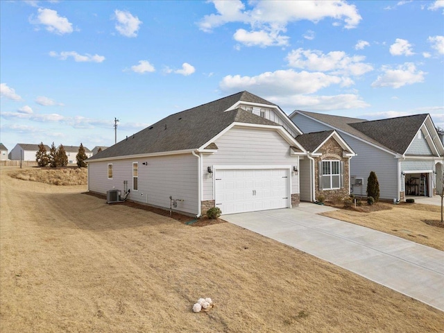 view of front of home with central AC and a front lawn