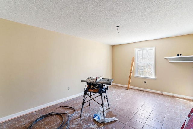 miscellaneous room with tile patterned flooring and a textured ceiling