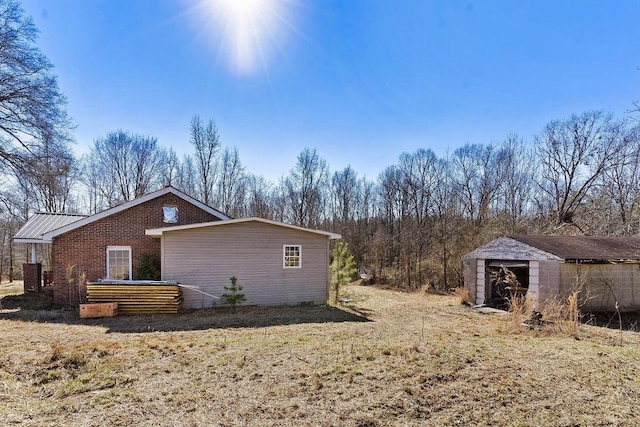 view of side of home with a storage shed