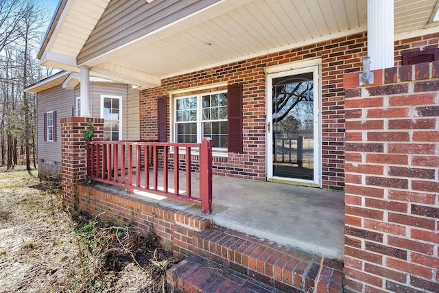 view of exterior entry with a porch