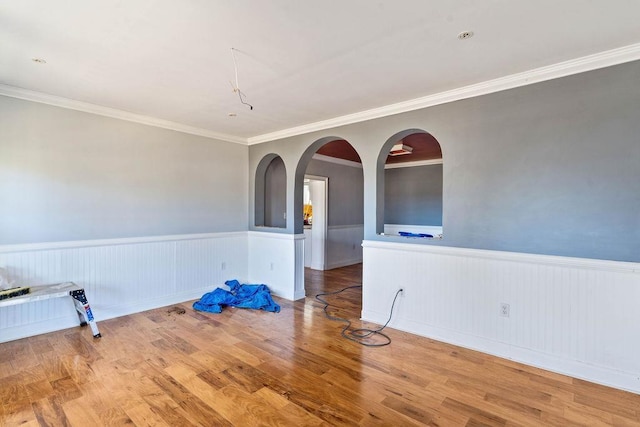 spare room featuring hardwood / wood-style floors and ornamental molding