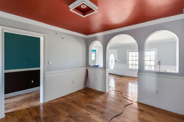 unfurnished room featuring hardwood / wood-style floors and ornamental molding