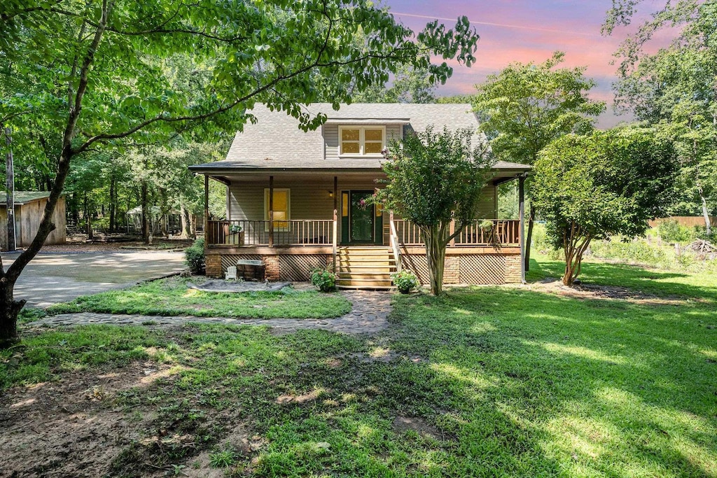 view of front of home with a yard and covered porch