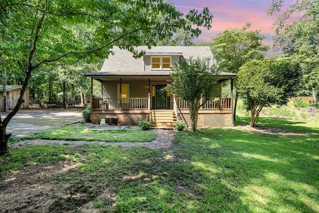 view of front of home with a yard and covered porch