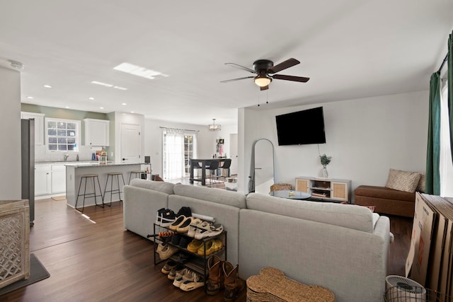 living room featuring dark hardwood / wood-style floors and ceiling fan