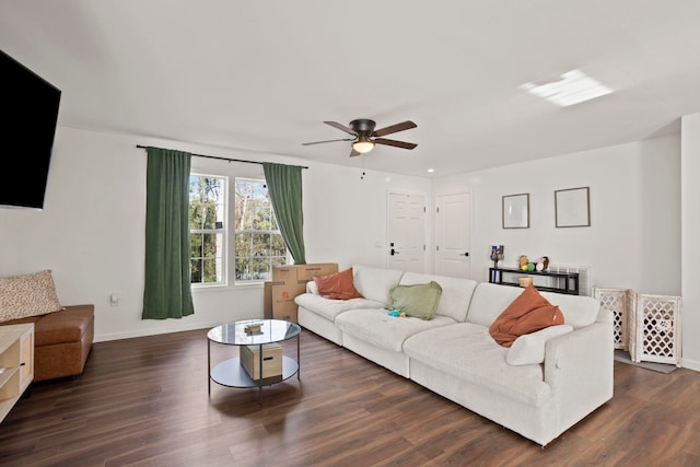 living room with ceiling fan and dark hardwood / wood-style flooring