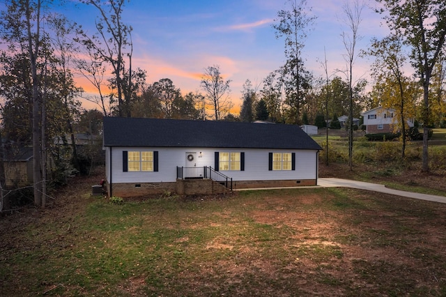 ranch-style house featuring a lawn