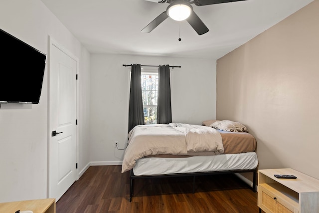 bedroom with ceiling fan and dark hardwood / wood-style floors