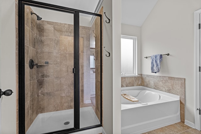 bathroom featuring tile patterned floors, lofted ceiling, and shower with separate bathtub