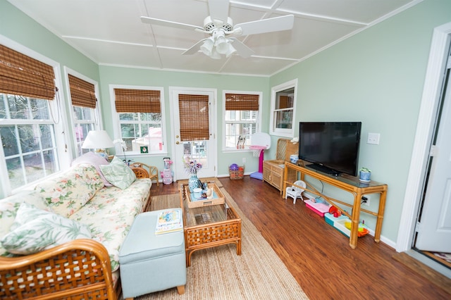 living room featuring hardwood / wood-style flooring, ceiling fan, and crown molding