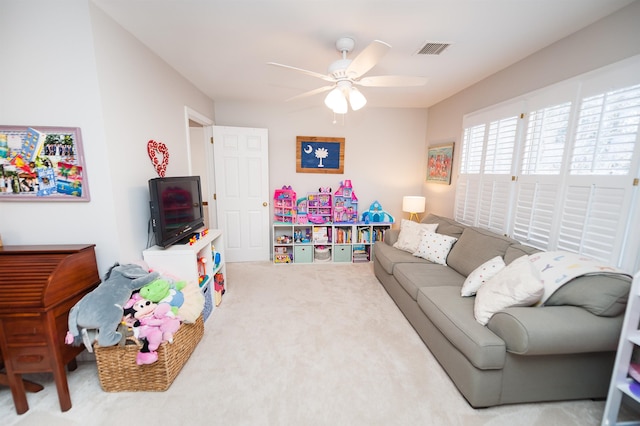 playroom with ceiling fan and carpet