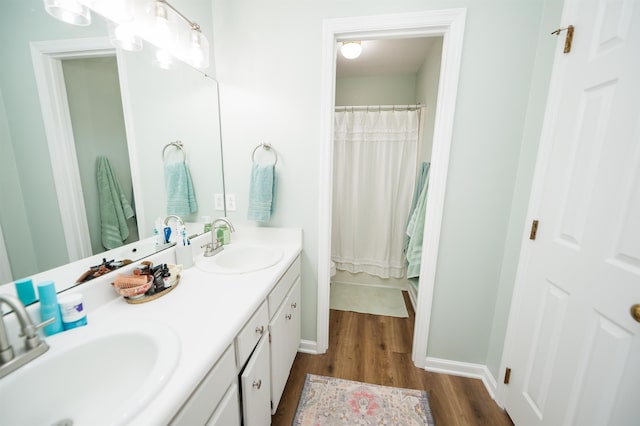 bathroom with vanity, hardwood / wood-style flooring, curtained shower, and toilet