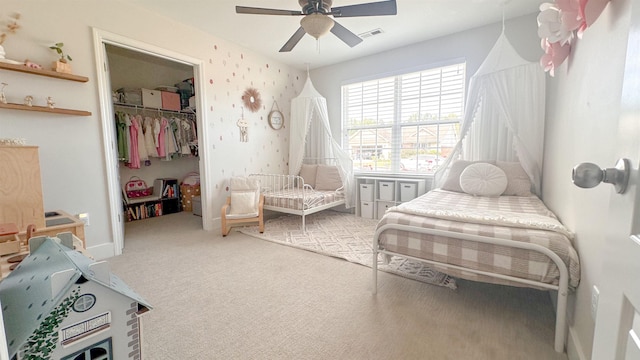 carpeted bedroom featuring a spacious closet, ceiling fan, and a closet