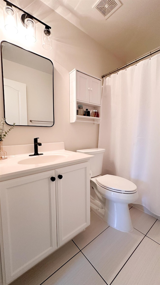 bathroom featuring vanity, tile patterned floors, toilet, and a shower with shower curtain