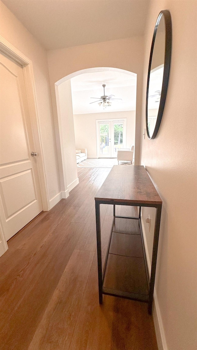 hallway with wood-type flooring and french doors