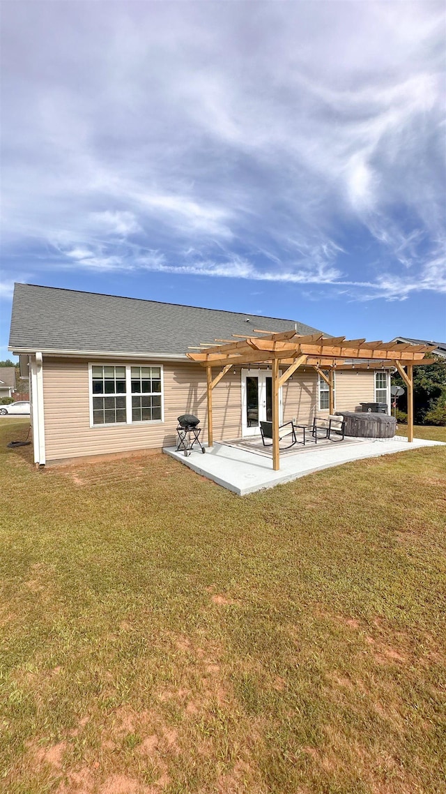 back of house featuring a pergola, a patio, and a lawn