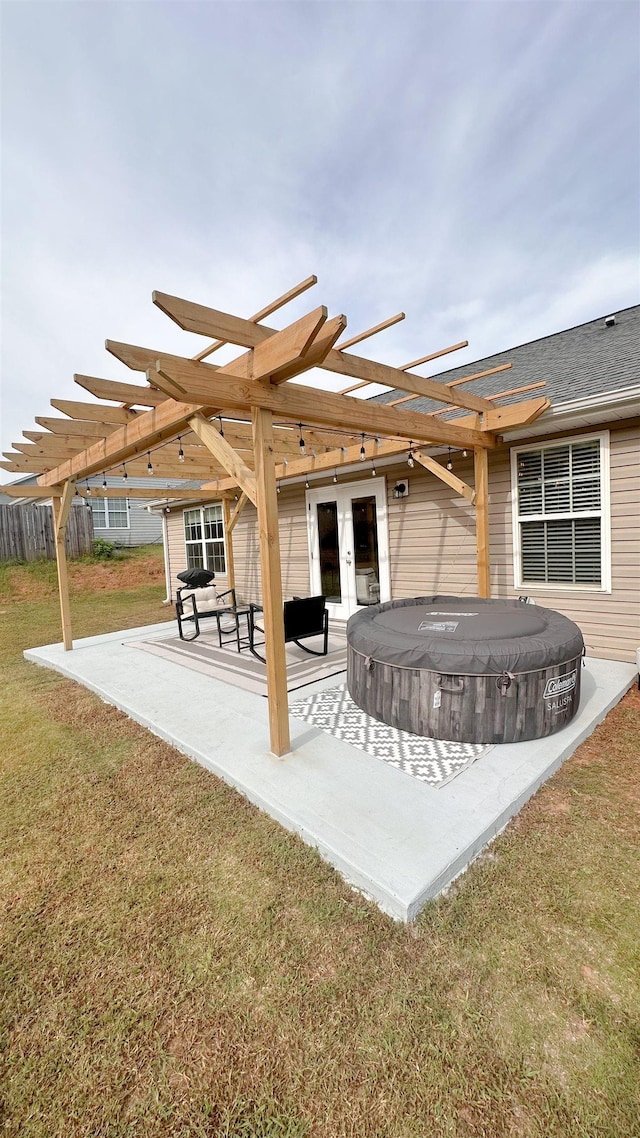 view of patio featuring a hot tub and french doors