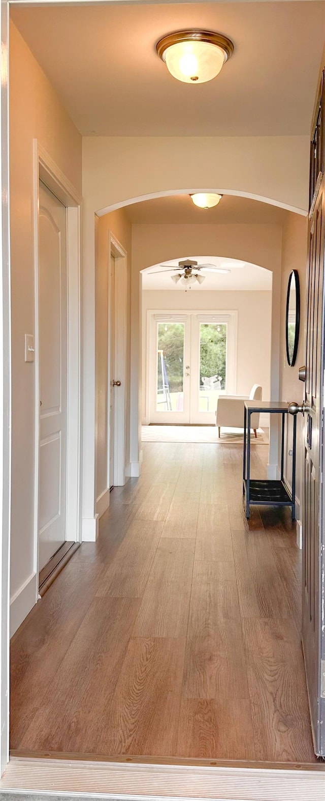 corridor featuring french doors and wood-type flooring