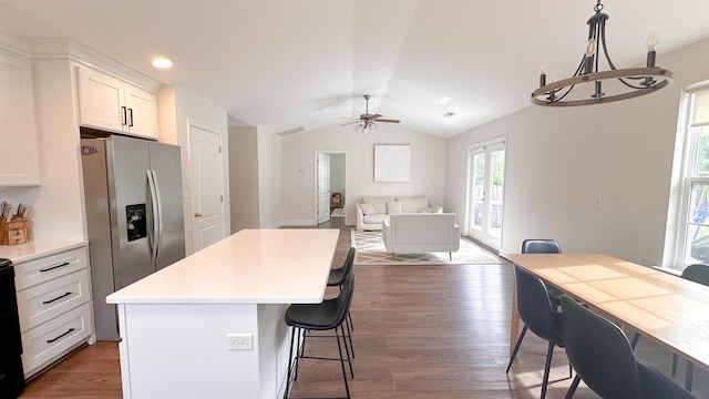 kitchen featuring lofted ceiling, hanging light fixtures, dark hardwood / wood-style floors, white cabinets, and a kitchen island