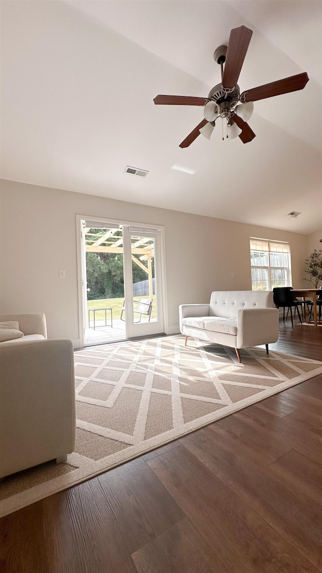 unfurnished living room featuring wood-type flooring, lofted ceiling, and ceiling fan