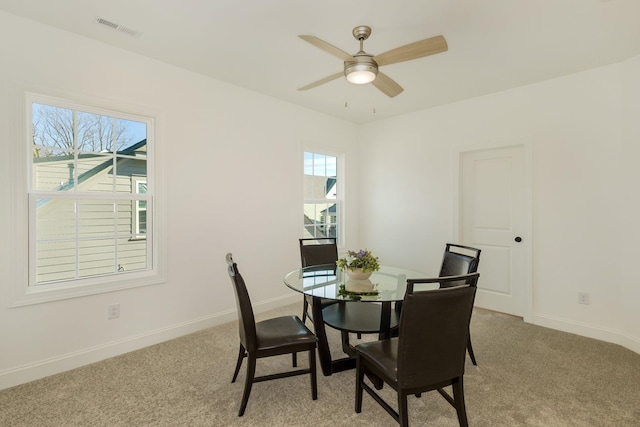 dining room featuring light carpet and ceiling fan